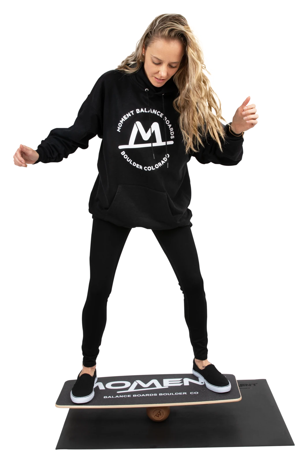Athlete balancing on the Moment Balance Board on its mat