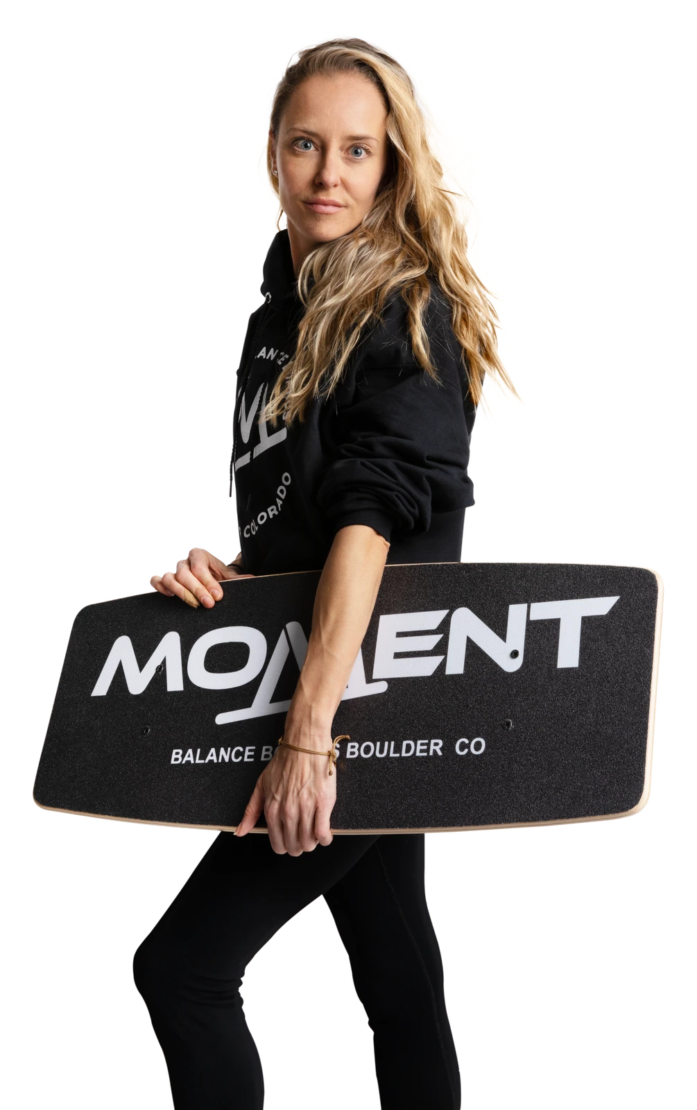 Athlete holding the Moment Balance Board and looking at the camera