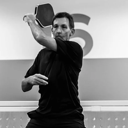 Scott Weiss mid swing on a pickleball court