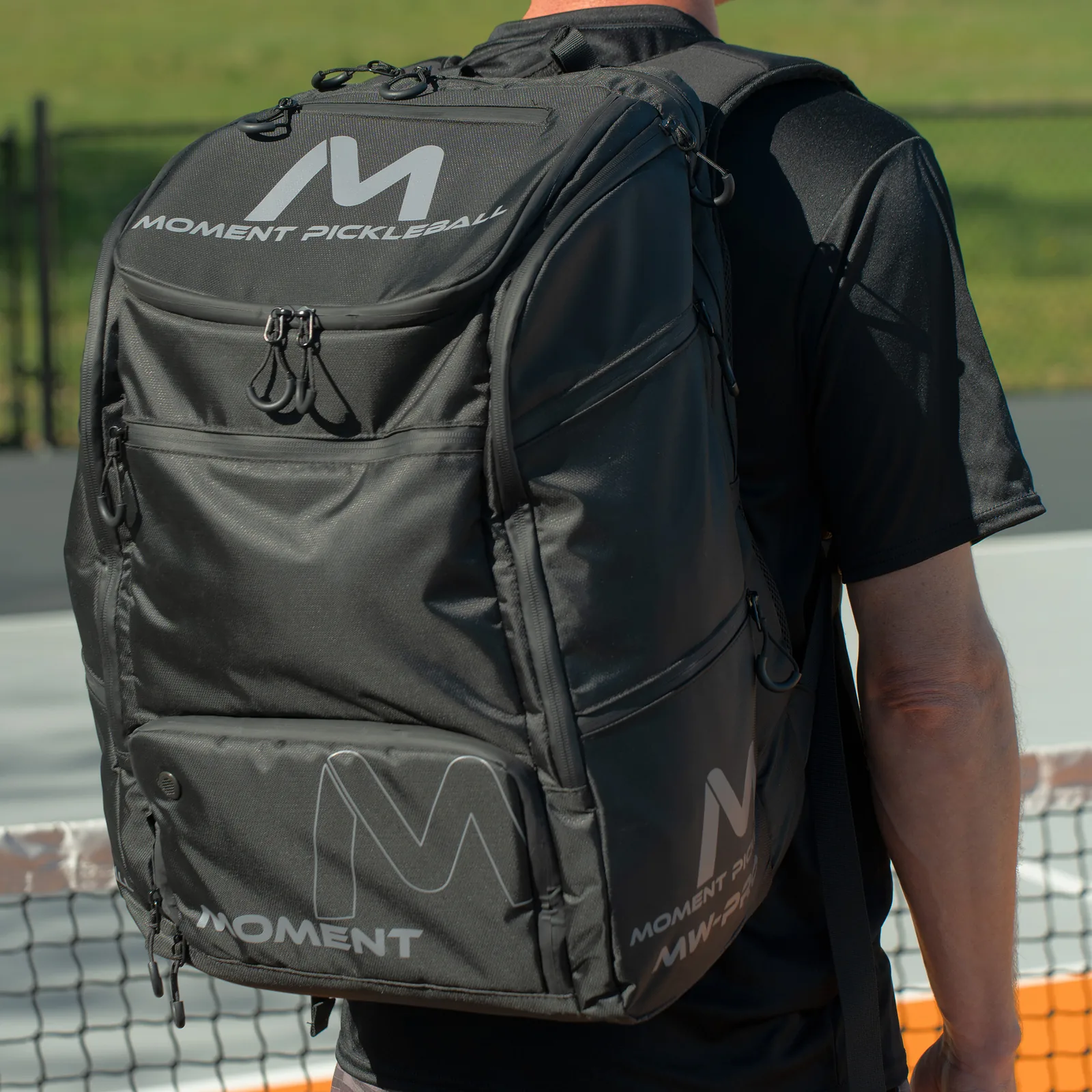 Player carrying a Moment MW-PRO bag onto the court